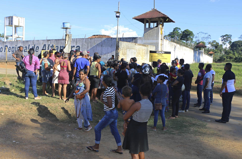 People seek information about family members who are prisoners after a riot inside the Regional Recovery Center in Altamira, Brazil, Monday, July 29, 2019. At least 57 prisoners were killed by other inmates during clashes between organized crime groups in the Altamira prison in northern Brazil Monday with 16 of the victims being decapitated, according to prison officials. (Wilson Soares/Panamazonica via AP)