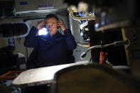 A Russian military cargo plane Il-76 crew member puts on headphones during a flight to the Alexandra Land island of the Franz Josef Land archipelago, Russia, Monday, May 17, 2021. Once a desolate home mostly to polar bears, Russia's northernmost military outpost is bristling with missiles and radar and its extended runway can handle all types of aircraft, including nuclear-capable strategic bombers, projecting Moscow's power and influence across the Arctic amid intensifying international competition for the region's vast resources. (AP Photo/Alexander Zemlianichenko)