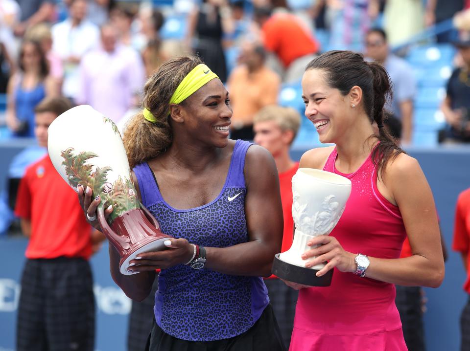 Serena Williams, left, and Ana Ivanovic laugh while posing with their trophies from the Western & Southern Open in 2014.