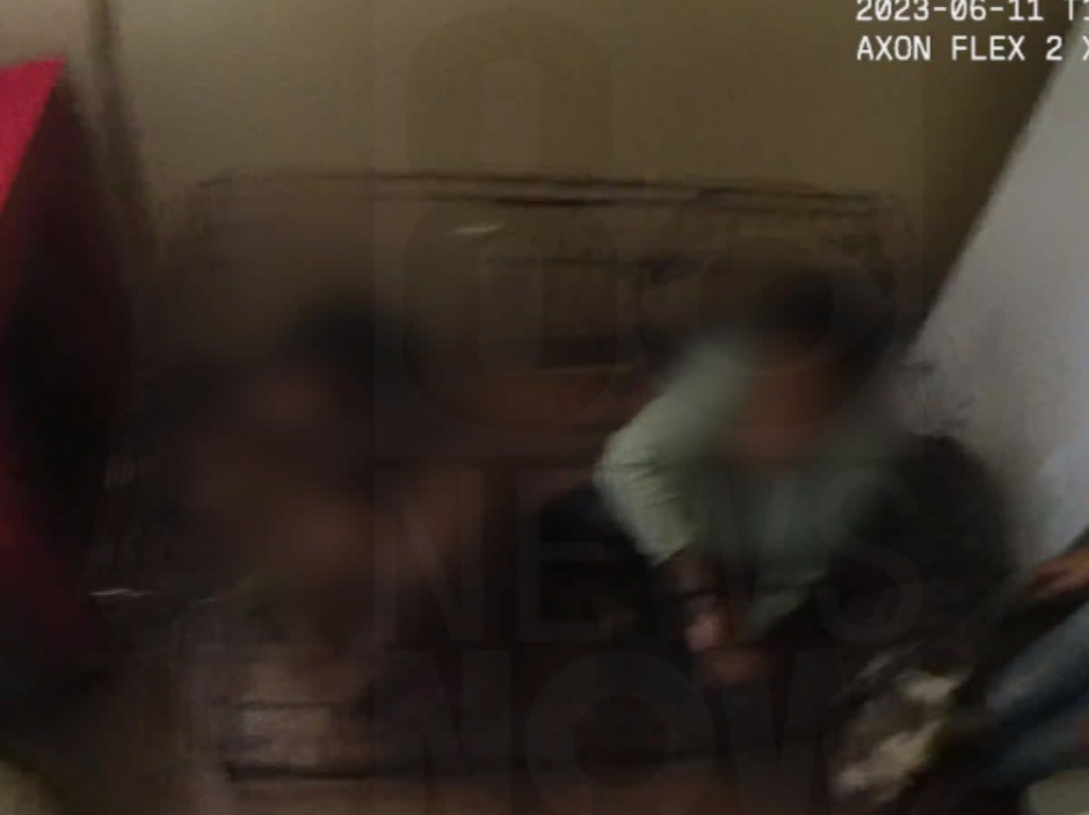 An image from Las Vegas Metro Police body camera footage showing two children locked inside a cage at a Las Vegas apartment (screengrab/Las Vegas Metro Police)