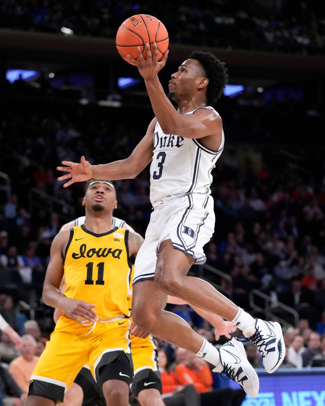 Duke’s Jeremy Roach (3) shoots against Iowa’s Tony Perkins (11) during the first half of the team’s NCAA college basketball game in the Jimmy V Classic, Tuesday, Dec. 6, 2022, in New York. (AP Photo/John Minchillo)