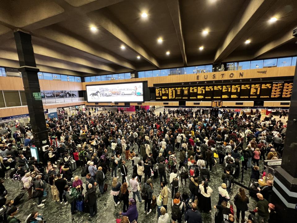 People wait for their trains inside Euston
