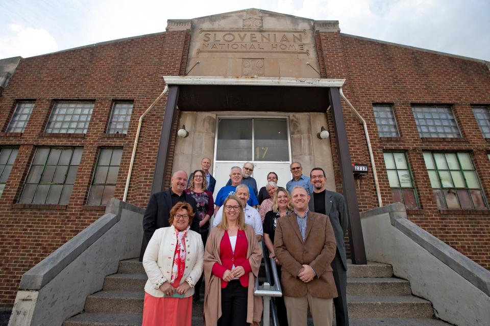 Local members of the Slovenian National Home and visiting members of the Slovenian government pose for a photo in front of the Slovenian National Home, Thursday, Sept. 23, 2021 in Haughville. The private social club was once a major social hub in Haughville but is now struggling to stay afloat. The Slovenian National Home is an historical relic of the neighborhood. Included in the photo are Consulate General of the Republic of Slovenia Alenka Jerak, front left, Minister for Slovenians Abroad Helena Jaklitsch, front center, and SNL Board President Phil Lambert.