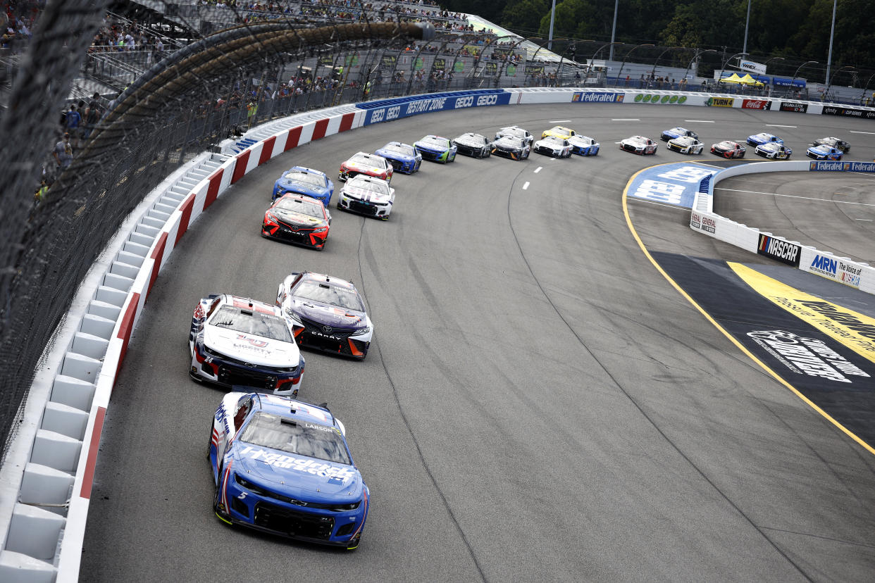 RICHMOND, VIRGINIA - AUGUST 14: Kyle Larson, driver of the #5 HendrickCars.com Chevrolet, William Byron, driver of the #24 Liberty University Chevrolet, and Denny Hamlin, driver of the #11 FedEx Freight Toyota, race during the NASCAR Cup Series Federated Auto Parts 400 at Richmond Raceway on August 14, 2022 in Richmond, Virginia. (Photo by Jared C. Tilton/Getty Images)