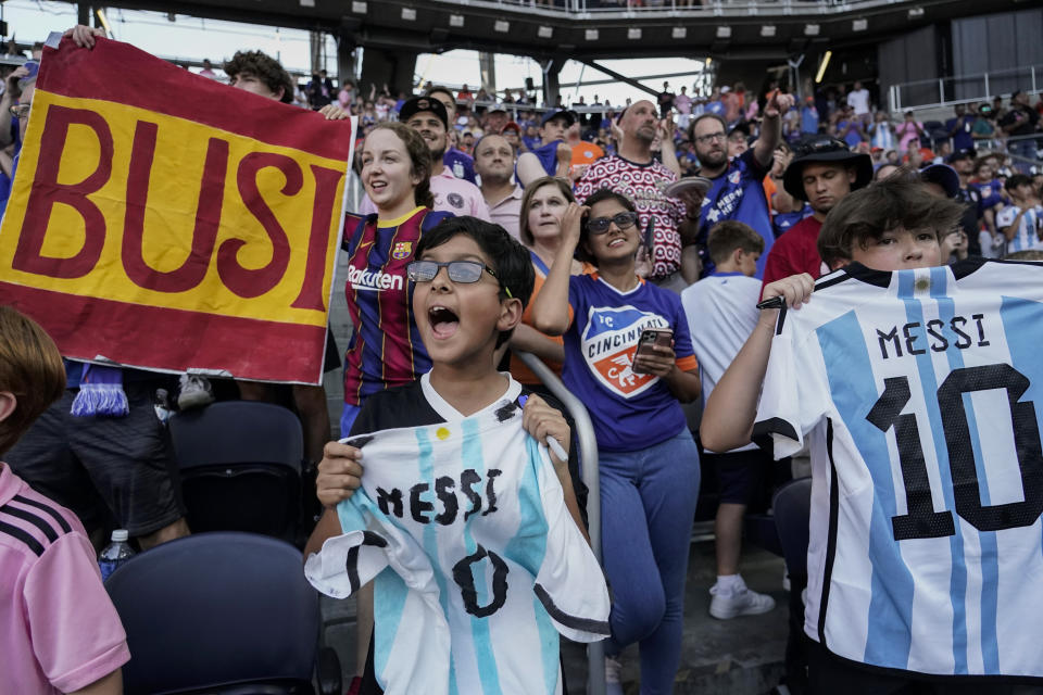 A fan cheers as Inter Miami's Lionel Messi warms up for the team's U.S. Open Cup soccer semifinal against FC Cincinnati, Wednesday, Aug. 23, 2023, in Cincinnati. (AP Photo/Joshua A. Bickel)