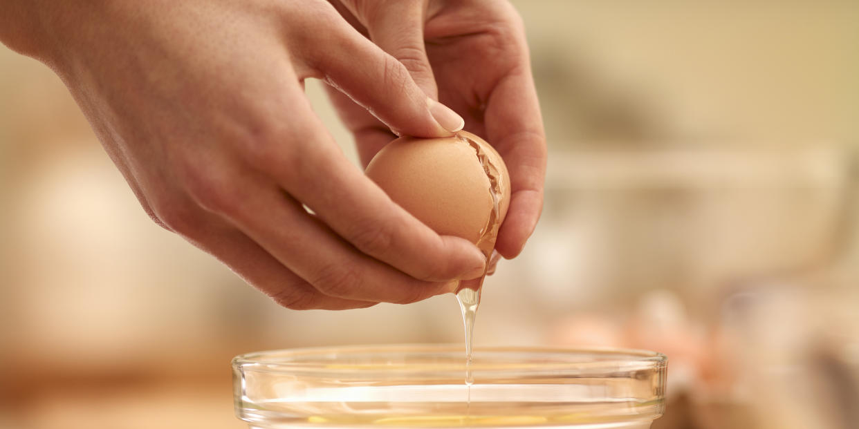 Woman cracking egg (Getty Images stock)