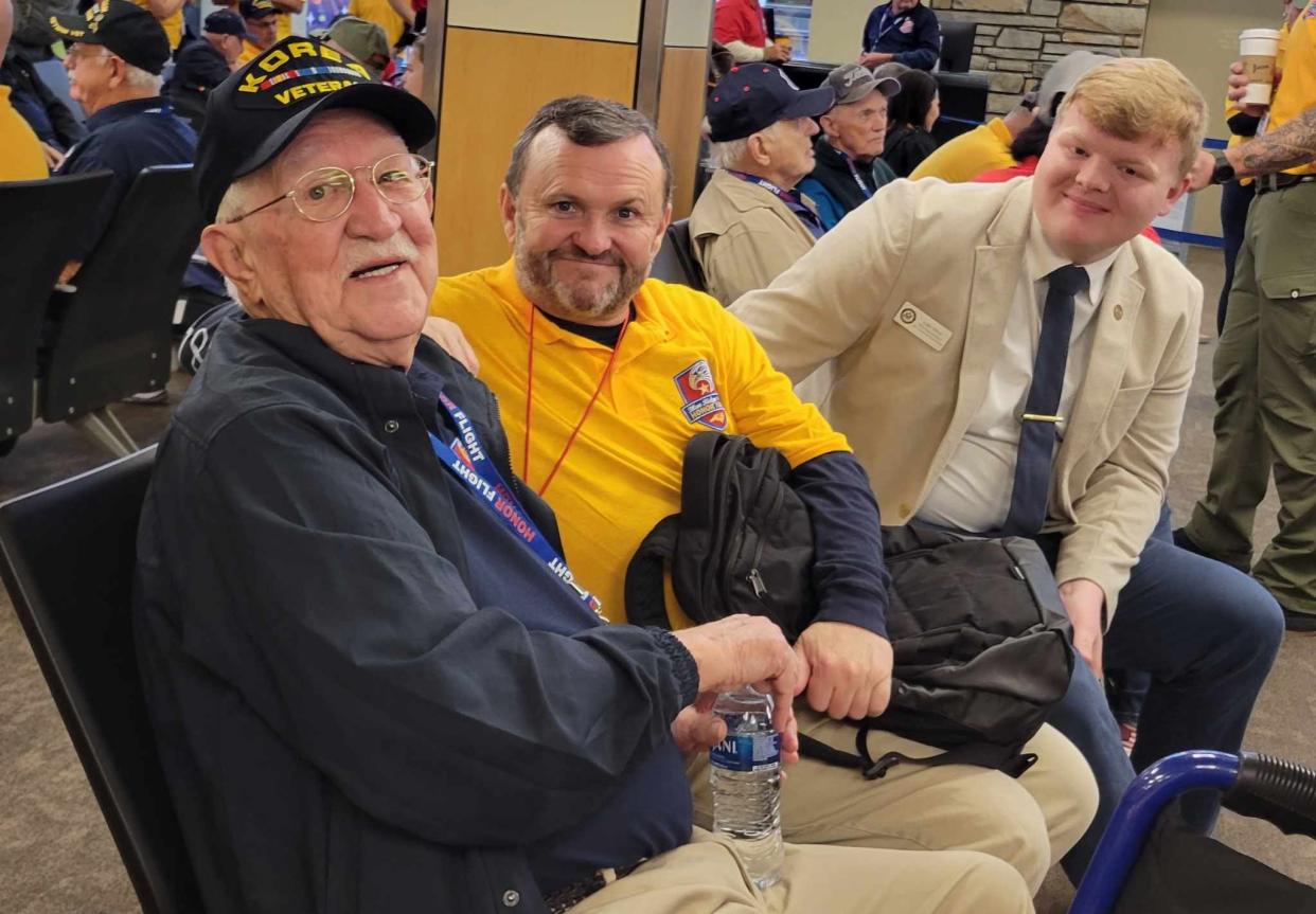 Former Crooked Creek Golf Club General Manager Tommy Laughter, center, sits with his veteran, Duane McCutchen, on April 27 at Asheville Regional Airport prior to the Blue Ridge Honor Flight. Laughter is now a regional field representative for Congressman Chuck Edwards. At right is Edwards' other field representative, Lake Silver.