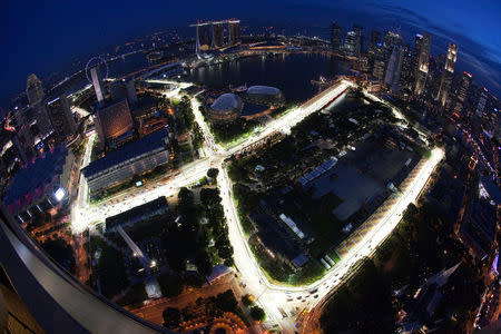 An aerial view shows the illuminated Marina Bay street circuit of the Singapore Formula One Grand Prix at dusk in Singapore September 20, 2010. Picture taken with a fish-eye lens. REUTERS/Edgar Su/File Photo