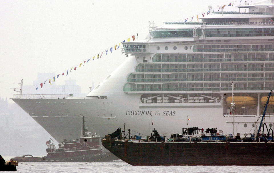 Bayonne, UNITED STATES:  The new cruise ship Freedom of the Seas, the world's largest cruise ship, owned by Royal Caribbean, gets caught in some barge traffic off the shores of Bayonne, New Jersey 12 May, 2006 in New York Harbor.   AFP PHOTO/DON EMMERT  (Photo credit should read DON EMMERT/AFP/Getty Images)