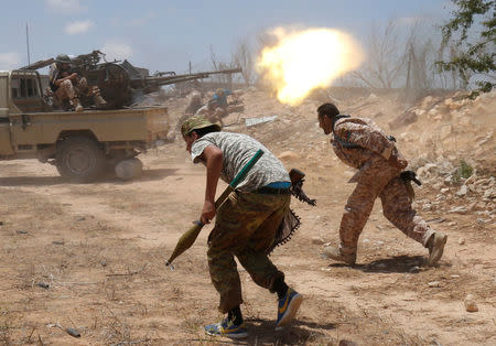 Libyan forces allied with the U.N.-backed government fire weapons during a battle with IS fighters in Sirte. REUTERS/Goran Tomasevic