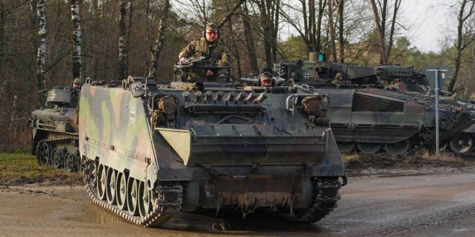 A Bundeswehr M113 armored personnel carrier stands during an exercise at the military training area.