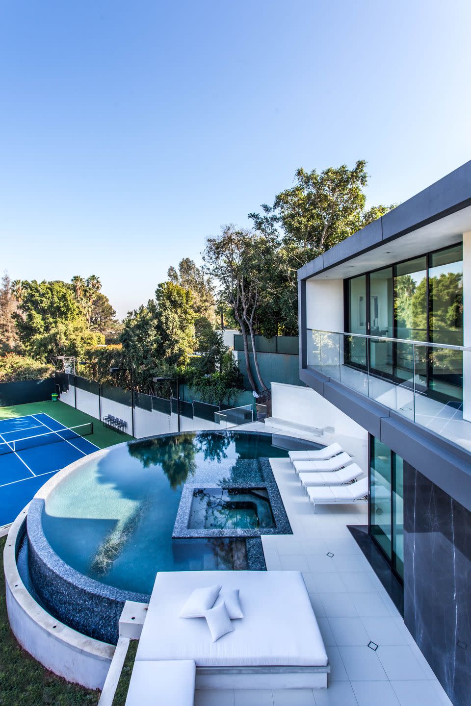 One of the Home's Two Pools, Which Overlooks the Full Tennis Court