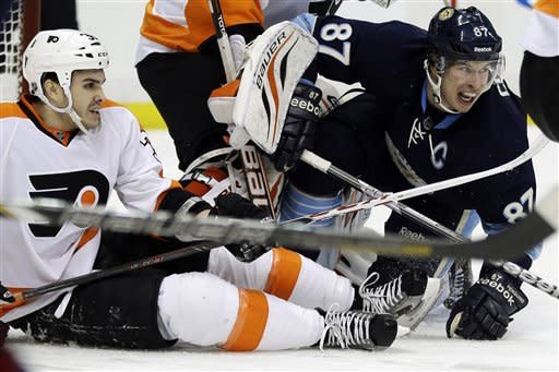 Pittsburgh Penguins center Sidney Crosby (87) and Philadelphia Flyers center Zac Rinaldo (36) collide in the second period of an NHL hockey game in Pittsburgh, Sunday, March 24, 2013. (AP Photo/Gene J. Puskar)