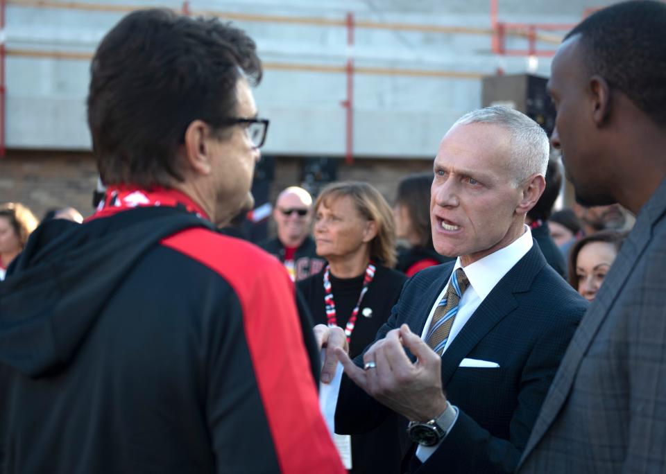 Big 12 commissioner Brett Yormark, right, visits with Texas Tech President Lawrence Schovanec before the Texas Tech-TCU game on Nov. 2 at Jones AT&T Stadium. The Big 12 on Thursday announced an agreement with professional wrestling outlet WWE to co-promote the conference's football championship game on Dec. 2 in Arlington.