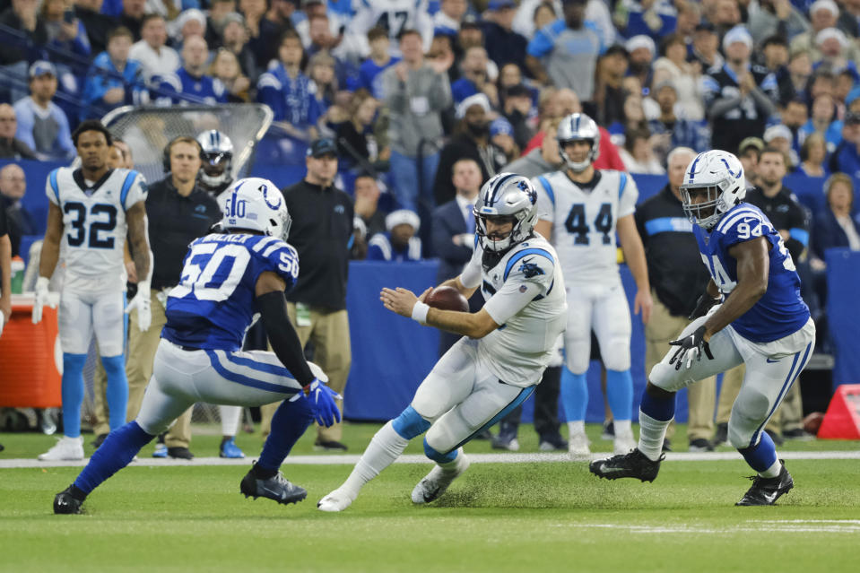 Carolina Panthers quarterback Will Grier (3) is tackled by Indianapolis Colts' Anthony Walker (50) and Tyquan Lewis (94) during the first half of an NFL football game, Sunday, Dec. 22, 2019, in Indianapolis. (AP Photo/AJ Mast)