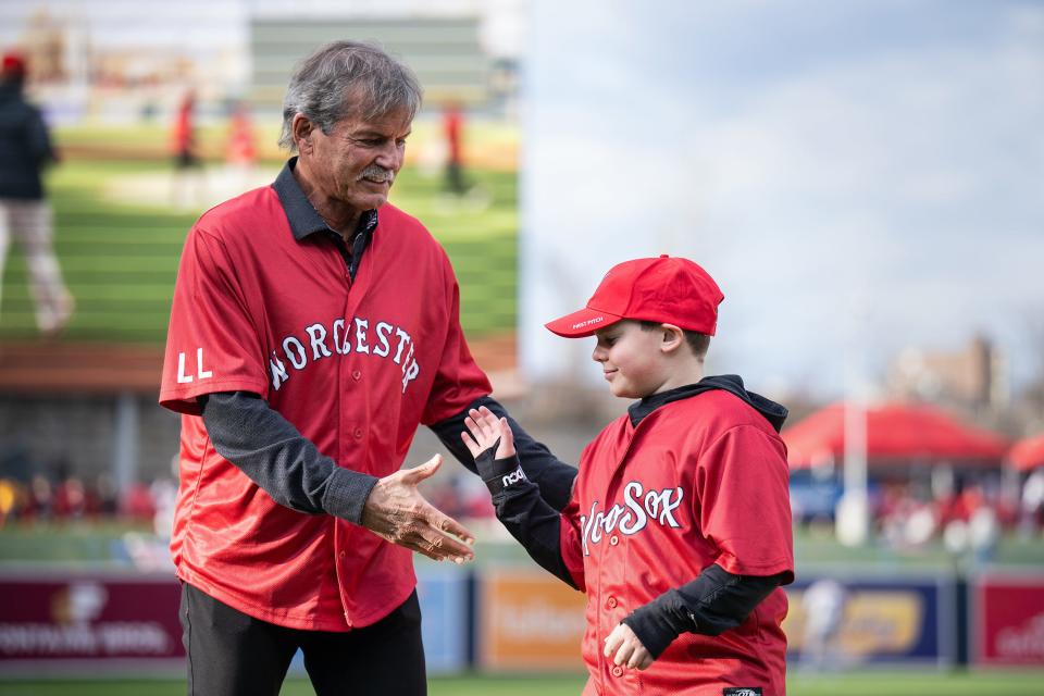 Red Sox great Dennis Eckersley congratulates Graham Phillips, a member of the Jimmy Fund, after tossing the first pitch at Polar Park on Friday.