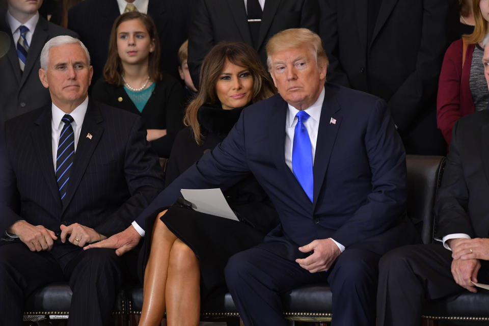 <p>President Donald Trump (R)reaches for Vice President Mike Pence as US First Lady Melania Trump looks on, during the memorial service for Reverend Billy Graham in the Rotunda of the U.S. Capitol on Feb. 28, 2018 in Washington. (Photo: Mandel NganAFP/Getty Images) </p>