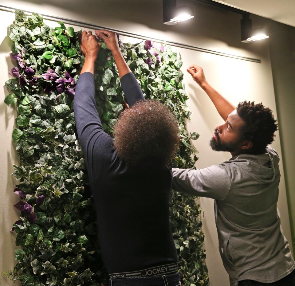 Gerald Trotter, left, manager of printing service at MATC  and D’Allen Davis, right, photography student, install materials for the ‘magical garden’ interactive station that is part of “Magical Black Tears” exhibition that opens on Feb. 1 at the Create Gallery on campus. The show is based on the book with the same name from author Decoteau Irby that tells the story from his children's perspective of the Sherman Park unrest in 2016. The exhibit teaches children ages 4-12 years how to create a more just and equitable world for Black people.  The purpose of the ‘magical garden’ is to collect tears from situations of injustice  and use them make a world a better place. The tears are symbolic of water being used to grow the garden.  Those visiting the gallery can read, write, create and pretend-play as well as problem-solve ways to create a world free from racism.  For more information on exhibit go to www.magicalblacktears.com