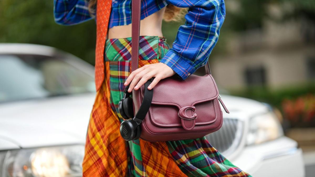 Who made Olivia Palermo's red bucket handbag, blue flared jeans, and beaded  pumps?