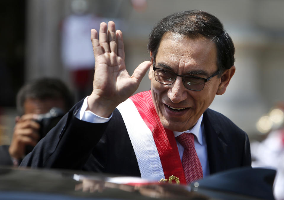 FILE - In tis March 23, 2018 file photo, Peru's newly-sworn in President Martin Vizcarra waves as he makes his way to the House of Pizarro, the presidential residence and workplace, also known as Government Palace, in Lima, Peru. Vizcarra, a soft-spoken engineer stepped into Peru's presidency earlier this year after his predecessor resigned amid scandal. (AP Photo/Karel Navarro, File)