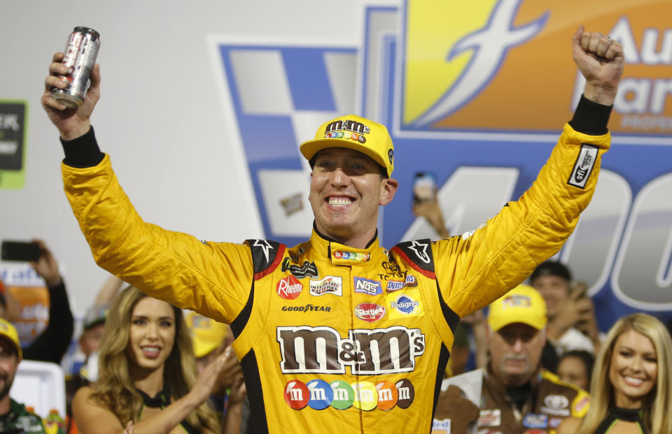 Kyle Busch (18) celebrates winning the NASCAR Cup Series auto race in victory lane at Richmond Raceway in Richmond, Va., Saturday, Sept. 22, 2018. (AP Photo/Steve Helber)