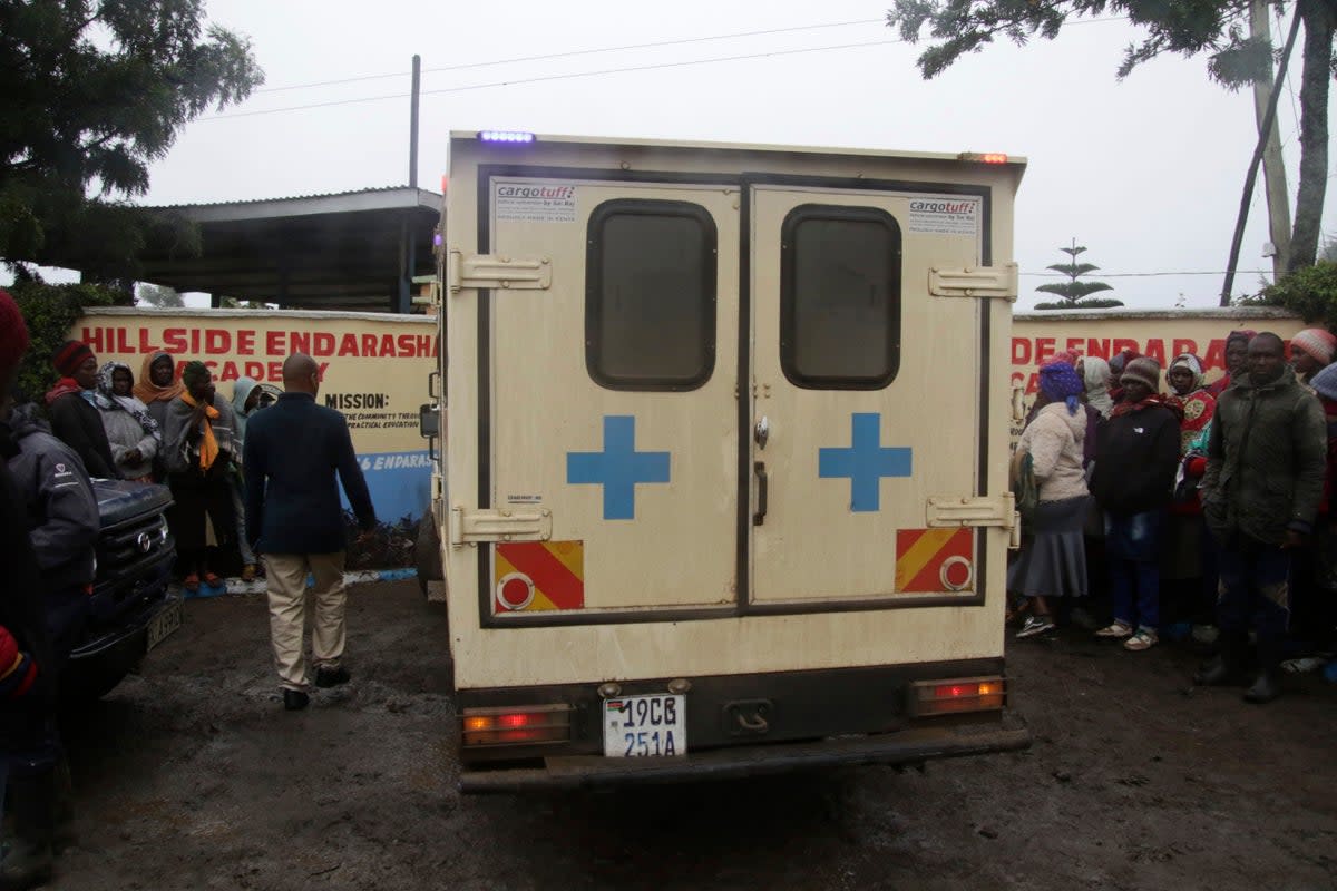 An ambulance drives inside the Hillside Endarasha Primary school following a fire incident in Nyeri, Kenya (AP)