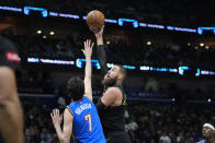 New Orleans Pelicans center Jonas Valanciunas shoots against Oklahoma City Thunder forward Chet Holmgren (7) in the first half of Game 4 of an NBA basketball first-round playoff series in New Orleans, Monday, April 29, 2024. (AP Photo/Gerald Herbert)