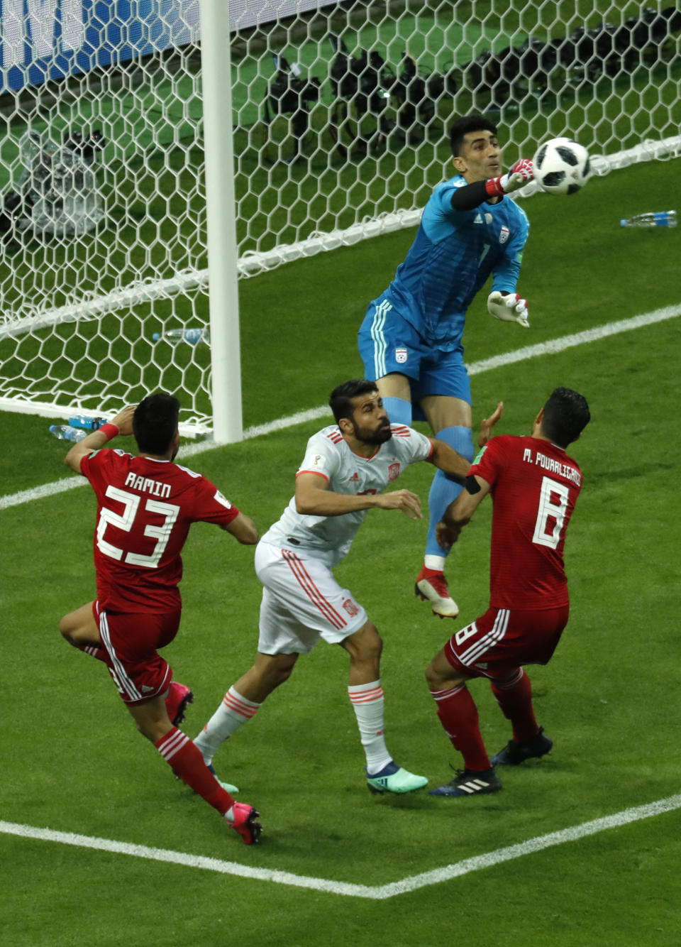 <p>Iran goalkeeper Ali Beiranvand punches away a ball during their Group B clash against Spain </p>