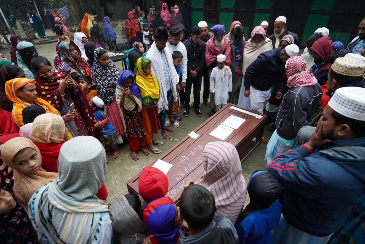 <span>Villagers attend the funeral of Shahadat, a Bangladeshi worker who died in Saudi Arabia. His death certificate gave ‘cardiac and respiratory arrest for unknown reasons’ as the cause of death.</span><span>Photograph: Pete Pattisson</span>