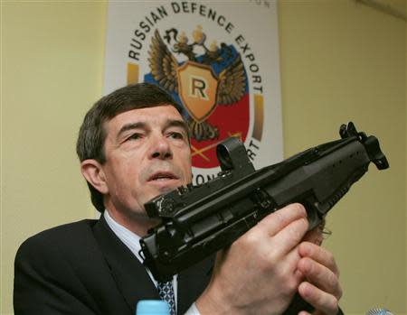 Anatoly Isaikin, director of Russia's Rosoboronexport, demonstrates a 9 mm sub-machine gun in central Moscow, in this July 27, 2005 file photo. REUTERS/Sergei Karpukhin/Files