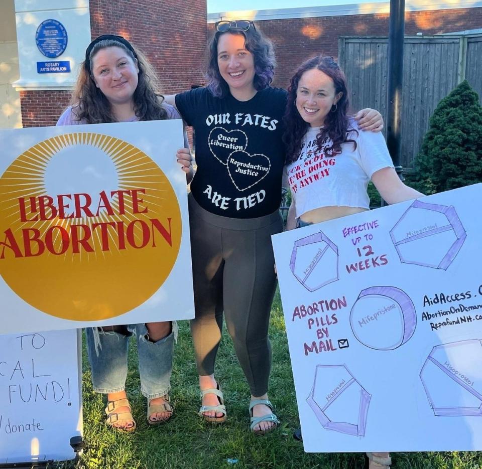 Members of the Reproductive Freedom Fund of New Hampshire, from left, Autumn Houle, patient and outreach coordinator; Josie Pinto, executive director; and Leah Cohen, outreach and community director at a  "Bans Off Our Bodies" rally in Dover, New Hampshire.