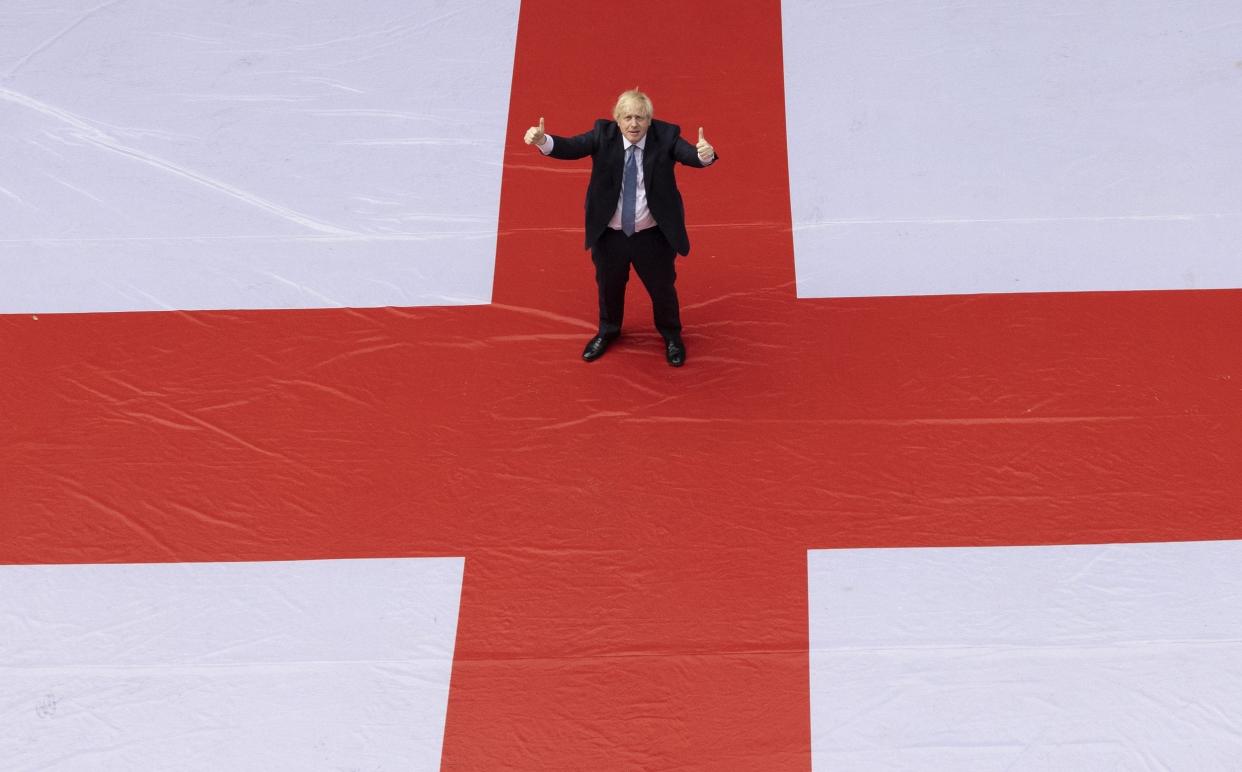 Boris Johnson standing on a giant St George's Cross before England’s quarter final match in the 2020 Euros - Simon Dawson/No 10 Downing Street/Getty