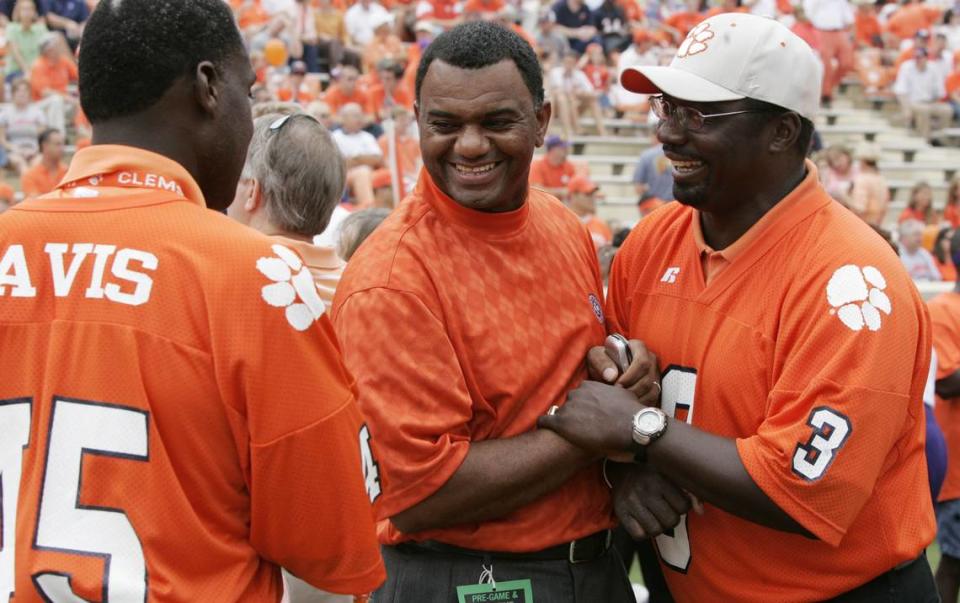 Former Clemson football players, from left, Jeff Davis, Perry Tuttle and Homer Jordan (3) greet each other as they meet for a special ceremony for to honor the 1981 national championship team Sept. 23, 2006.