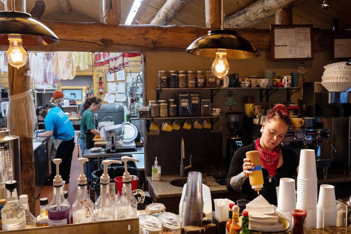 Stanley Baking Co. employees prepare food in the kitchen and coffee beverages up front as the restaurant opens for breakfast in June.