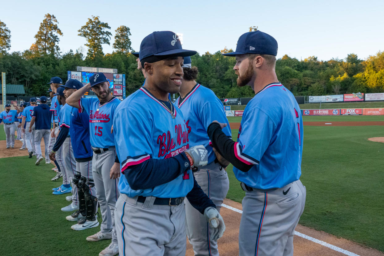 Blue Wahoos shortstop Nasim Nunez is greeted by teammates before Game 2 of Southern League championship series at Smokies Stadium in Kodak, Tennessee.