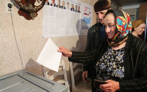 A woman casts her ballot at a polling station in Chechnya - Credit: Yelena Afonina/TASS via Getty Images