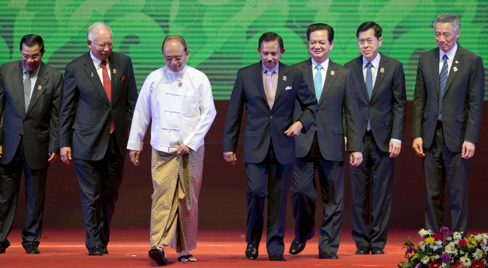 CORRECTS THE ID OF VIETNAMESE LEADER - Leaders of the Association of Southeast Asian Nations walk after posing for a photograph during the 24th ASEAN leaders Summit in Naypyitaw, Myanmar, Sunday, May 11 2014. Leaders from left, Cambodian Prime Minister Hun Sen, Malaysian Prime Minister Najib Razak, Myanmar President Thein Sein, Sultan of Brunei Hassanal Bolkiah, Vietnamese Prime Minister Nguyen Tan Dung, Thailand caretaker Deputy Prime Minister Phongthep Thepkanjana, Singaporean Prime Minister Lee Hsien Loong. (AP Photo/Gemunu Amarasinghe)
