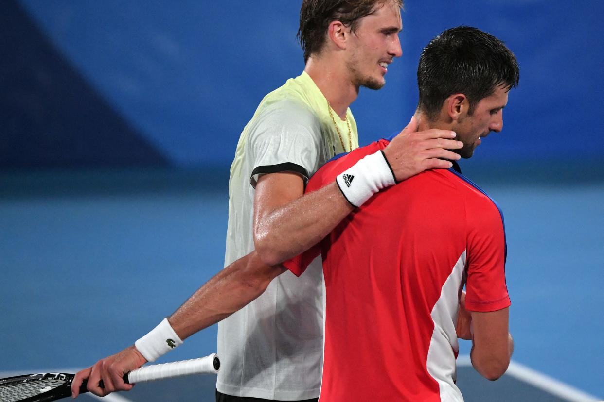 Alexander Zverev, left, stunned Novak Djokovic in the Olympic men's tennis semifinals and ended Djokovic's pursuit of the Golden Slam. (Photo by TIZIANA FABI/AFP via Getty Images)