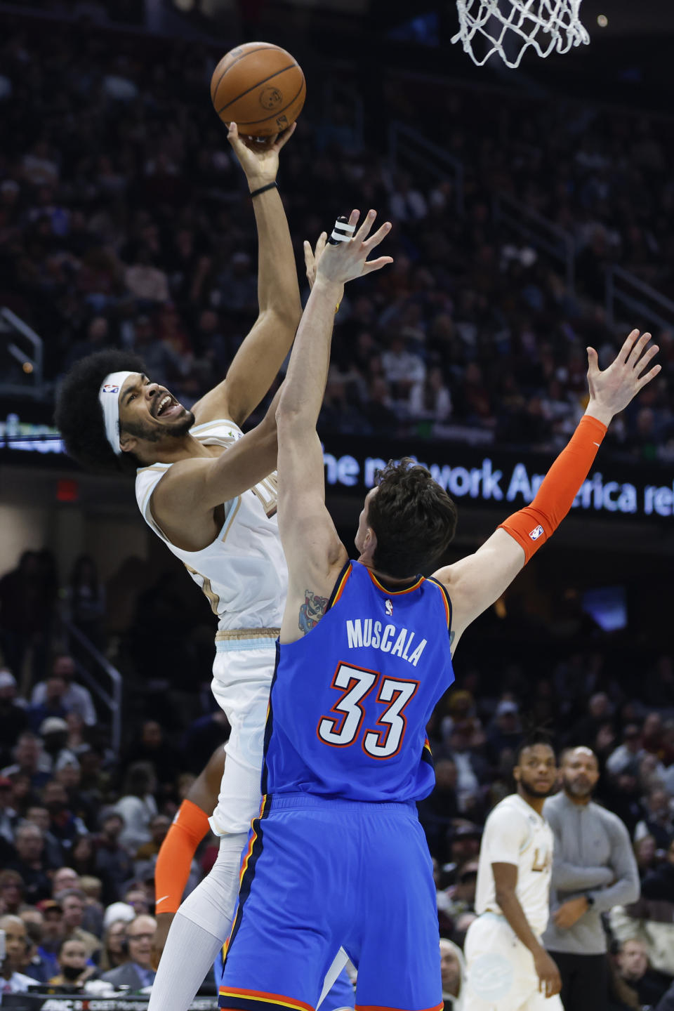 Cleveland Cavaliers center Jarrett Allen, left, shoots against Oklahoma City Thunder center Mike Muscala (33) during the first half of an NBA basketball game, Saturday, Dec. 10, 2022, in Cleveland. (AP Photo/Ron Schwane)