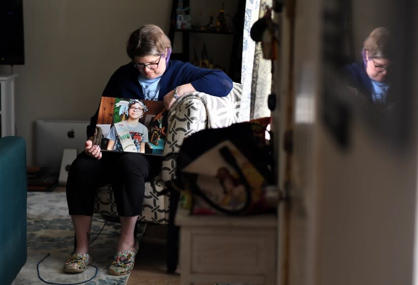 Dickinson, Texas May 29, 2022- Rhonda Hart holds a picture of her daughter, Kimberly Vaughn who was one of ten people killed in a mass shooting at Santa Fe High School in Texas. (Wally Skalij/Los Angeles Times)