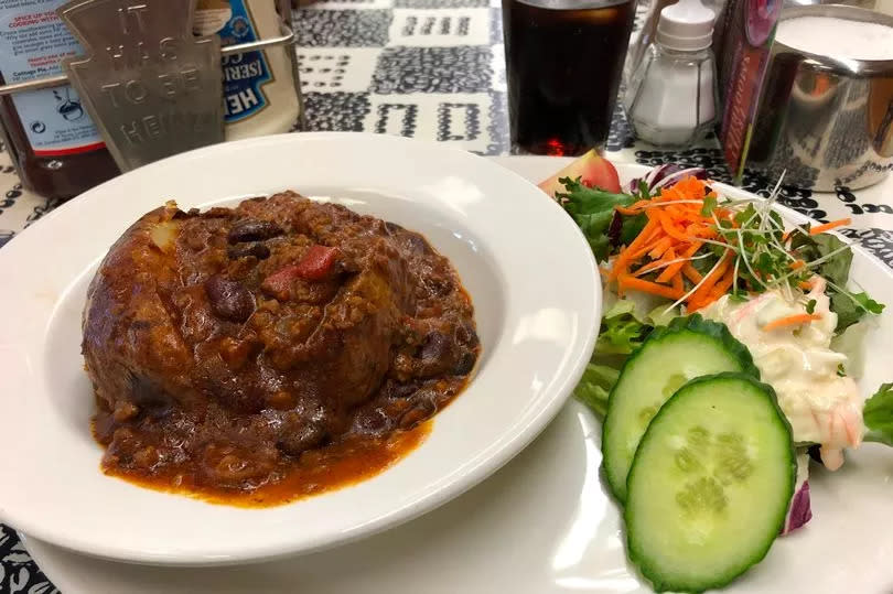 A jacket potato with chilli con carne served at The Kardomah -Credit:WalesOnline