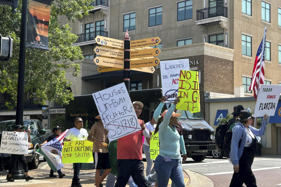 Protestors opposed to a new law cracking down on employers who hire immigrants in the country illegally march to the Florida Capitol, Friday, June 30, 2023, in Tallahassee, Fla. (AP Photo/Brendan Farrington).