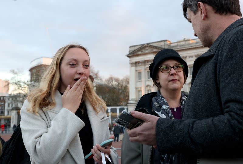 People gather outside Buckingham Palace in London