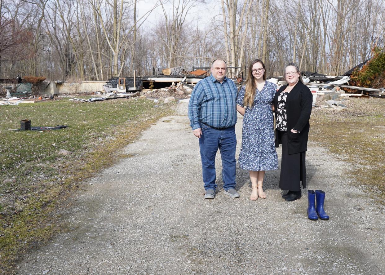 The Dalton family — from left, Ryan, Sabrie and Rebecca — after pictured March 26 outside what remains of their home on Allen Road in Tecumseh.