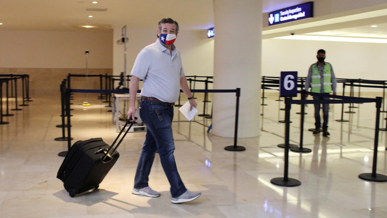 U.S. Senator Ted Cruz (R-TX) carries his luggage at the Cancun International Airport before boarding his plane back to the U.S., in Cancun, Mexico February 18, 2021. (Stringer/Reuters)
