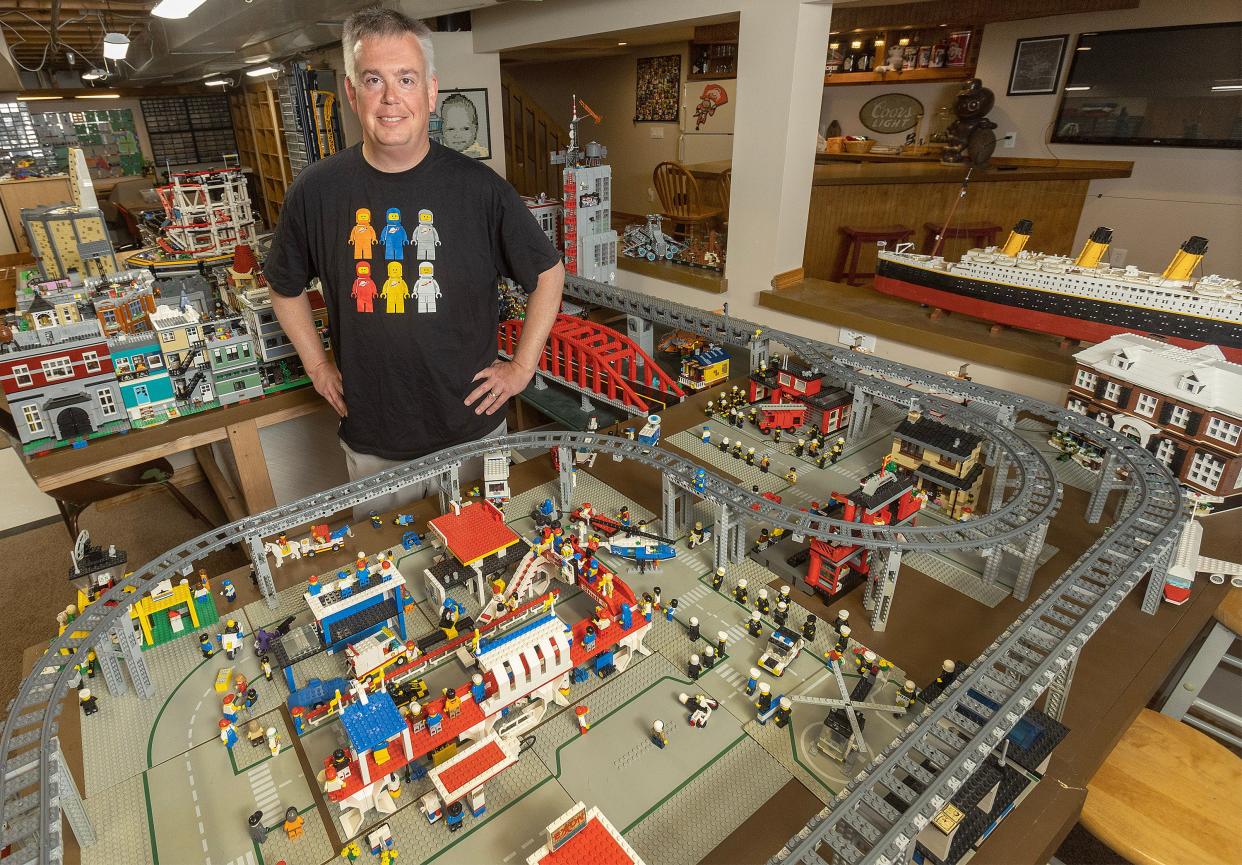 Lego collector Scott Brown stands among just a few of the scenes he's created in his Plain Township basement.