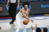 Cleveland Cavaliers' Jarrett Allen, center, passes to Isaac Okoro during the second half of an NBA basketball game against the Brooklyn Nets Sunday, May 16, 2021, in New York. (AP Photo/Frank Franklin II)