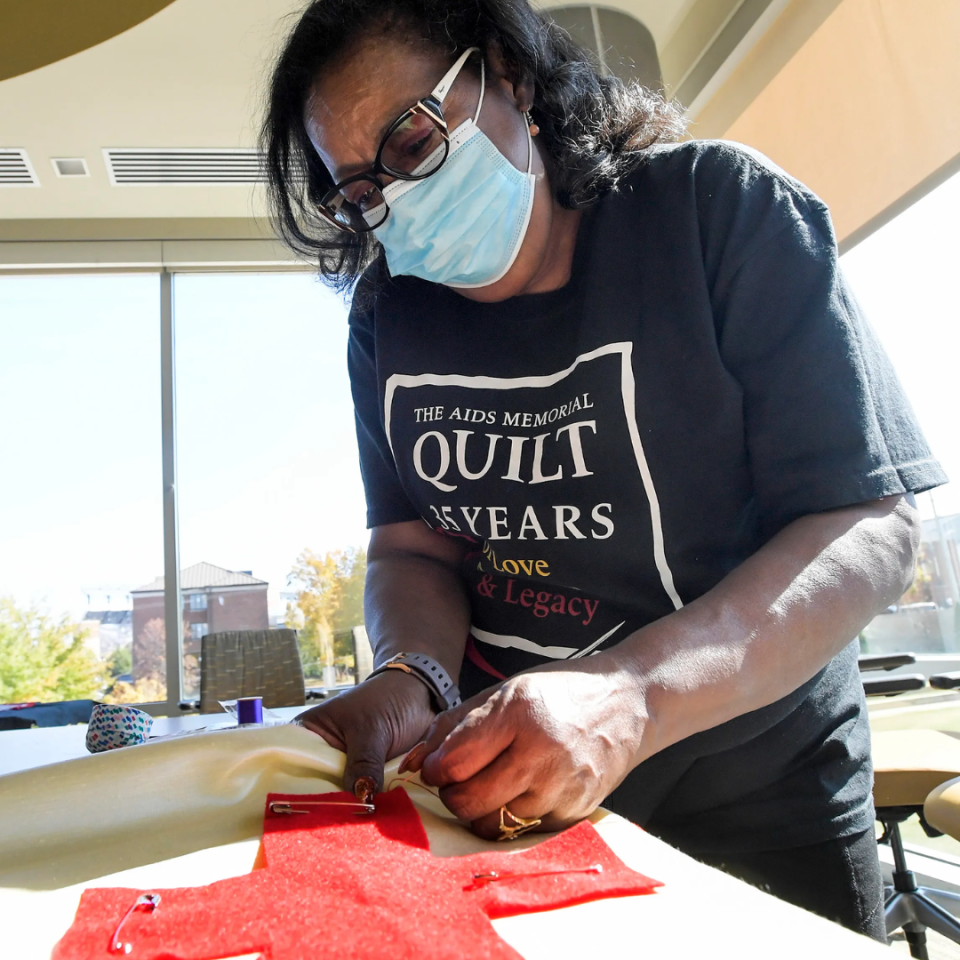 Stephanie Laster works on quilts honoring Black and brown lives lost to HIV/AIDS during the Change the Pattern event held on the Alabama State University campus in Montgomery, Ala., on Friday, Nov. 4, 2022.