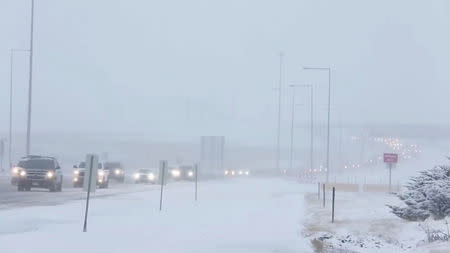Cars move along a snow-covered road in Denver, U.S., January 22, 2019 in this video grab obtained from social media video by Reuters January 28, 2019. Denver International Airport/via REUTERS