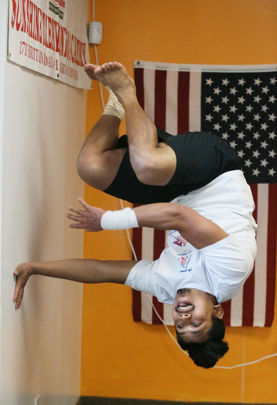 Dinesh Sunar sets a Guinness World Record for the most circular jumps off a wall in one minute Feb. 10 at Sunshine Taekwondo Academy in Akron. Sunar successfully completed 16 circular jumps in just under a minute.